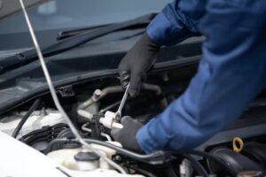 A mechanic working on a car engine