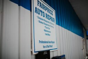 A sign for an auto repair shop. The sign reads "FAIRPRICE AUTO REPAIR" and lists various services.