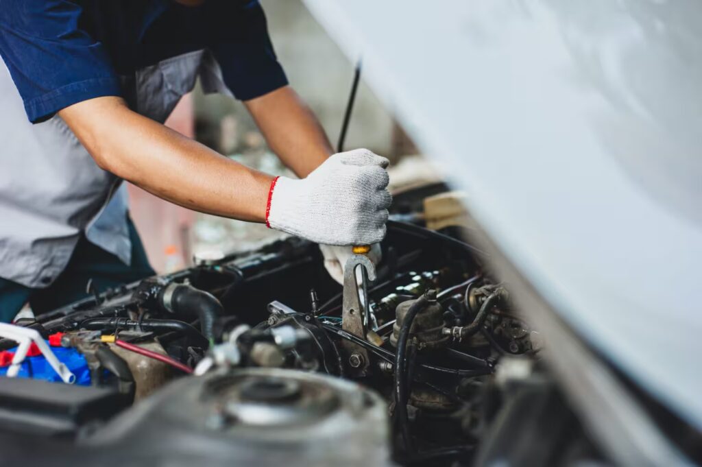 A mechanic working on a car engine