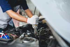 A mechanic working on a car engine