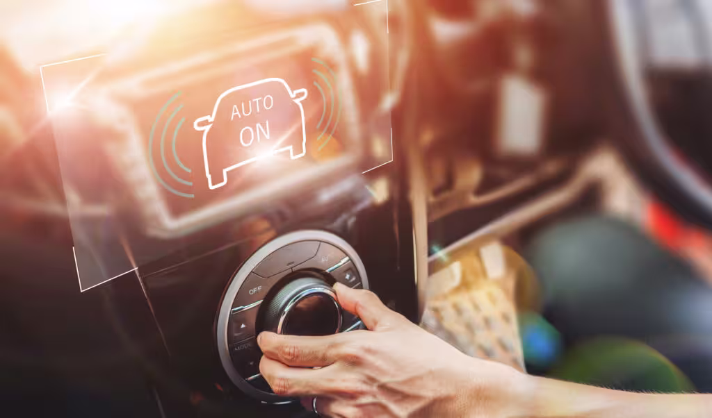 A hand turning a car’s control knob with an "Auto On" digital interface overlay.