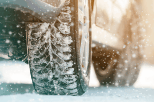 Winter tire services, auto repair in Long Lake, MN by Arvu Auto. Image of a vehicle tire covered in snow, emphasizing safe traction, seasonal maintenance, and reliable performance in winter driving conditions.