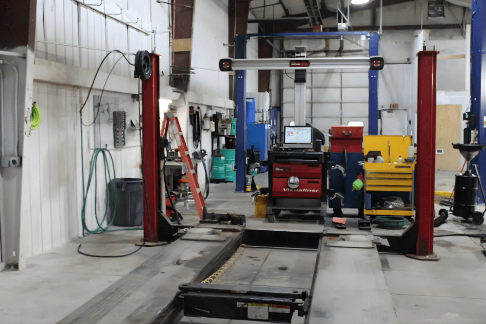 Auto Repair Near Hollywood, MN. Image of a modern alignment machine and lift in an auto repair shop, showcasing advanced equipment for precise steering and tire performance.