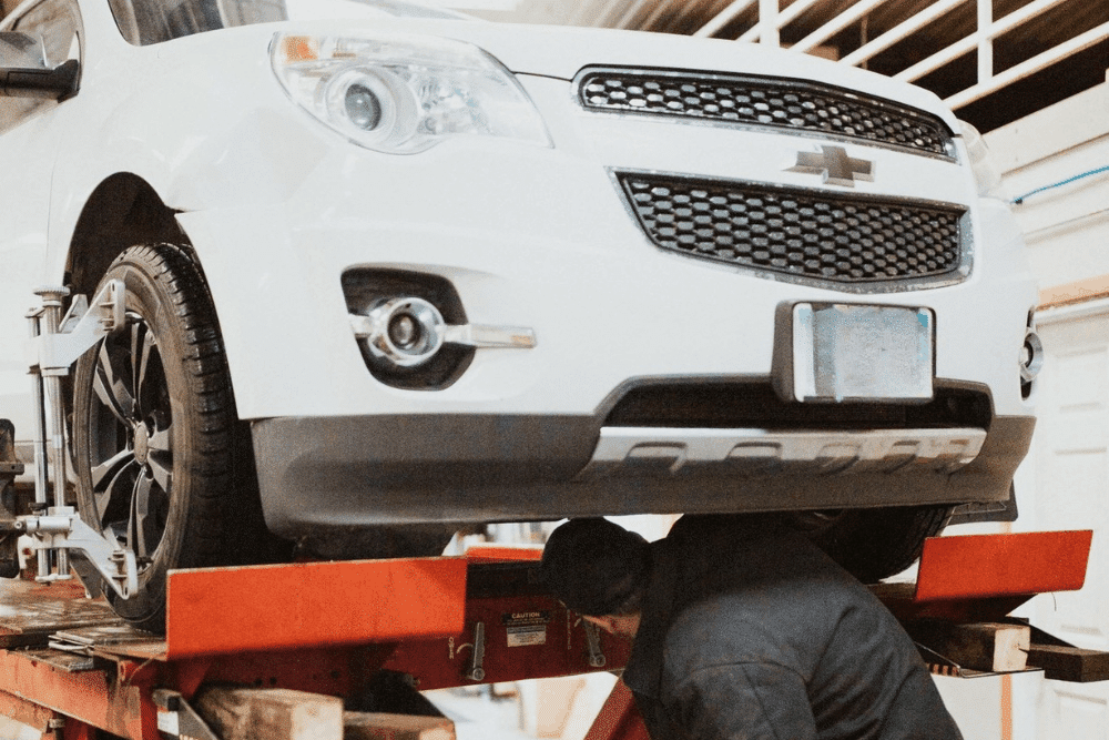 Car maintenance, auto repair in Long Lake, MN by Arvu Auto. Image of a vehicle positioned on an alignment rack with precision equipment, ensuring accurate wheel alignment, improved handling, extended tire life, and safer driving performance.