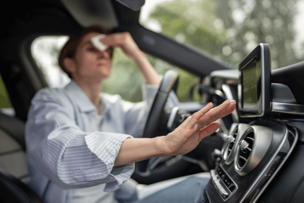 Auto a/c repair in Long Lake, MN by Arvu Auto. Image of driver struggling with heat inside vehicle, highlighting the importance of professional A/C diagnostics and service for comfort and reliable cooling performance.