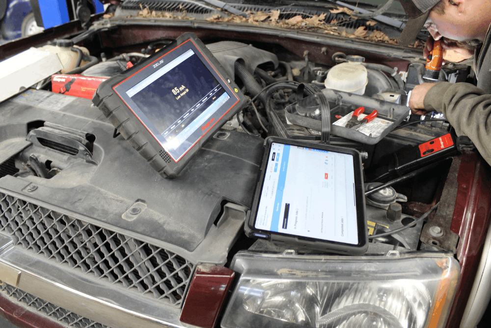 Strange car noises, auto repair in Cokato, MN at Arvu Auto. Image of a technician using advanced diagnostic scan tools and digital inspection equipment to identify engine, electrical, and performance issues for accurate auto repair services.