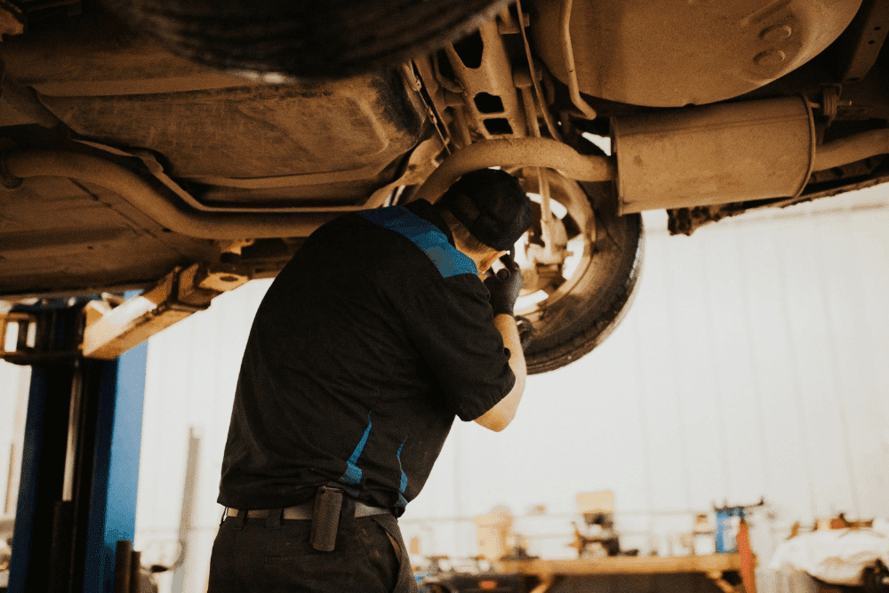 Pre-trip inspection, auto repair in Watertown, MN at Arvu Auto. Image of a technician inspecting and repairing the vehicle suspension and brake components on a lift to improve ride quality, handling, and driving safety.