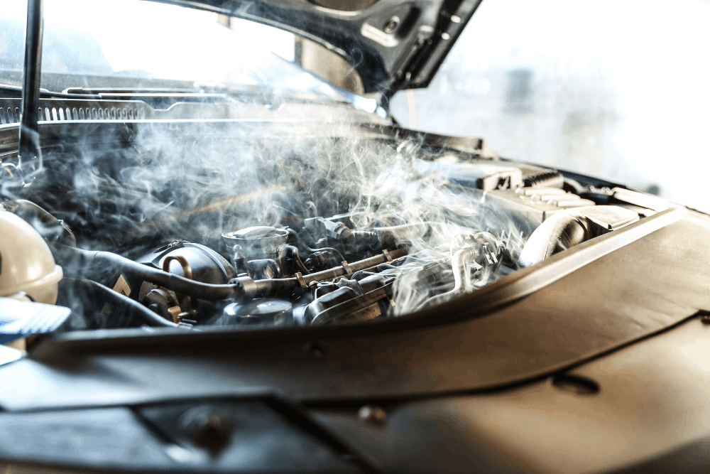 Car overheating, auto repair in Watertown, MN, at Arvu Auto. Image of a steam rising from an overheated vehicle engine with the hood open, illustrating engine overheating caused by cooling system problems that require immediate diagnosis and repair.
