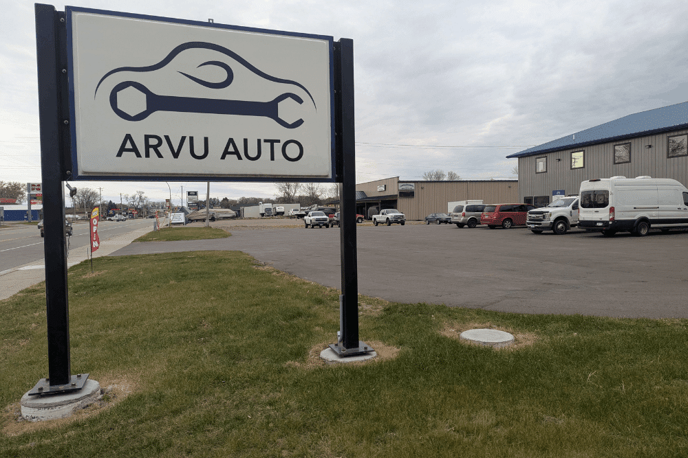 Vehicle care, auto repair in Cokato, MN, at Arvu Auto. Roadside sign for Arvu Auto in Cokato, MN, directing drivers to a trusted local auto repair shop offering summer vehicle maintenance, diagnostics, preventative maintenance, and complete automotive repair services.