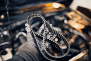 timing belt replacement, auto repair in Long Lake, MN, at Arvu Auto. Image of a worn timing belt removed during engine service, highlighting preventative maintenance that protects engine performance, reliability, and helps prevent costly engine damage.
