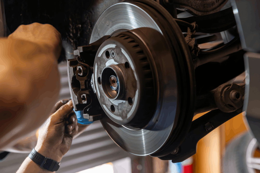 Brake warning signs, auto repair in Long Lake, MN at Arvu Auto. Image of a technician servicing a vehicle’s brake rotor and caliper to help maintain safe, smooth, and reliable braking performance.